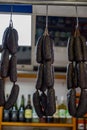 Spanish sausages black chorizo hanging on butchers shop on farmers market