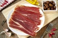 Spanish serrano ham and black olives served as tapas Royalty Free Stock Photo