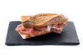 Spanish serrano ham sandwich isolated on white background. Royalty Free Stock Photo
