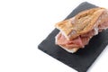 Spanish serrano ham sandwich isolated on white background. Spanish bocadillo de jamon serrano Royalty Free Stock Photo