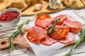 Spanish sliced chorizo sausage on a cutting board. cured meat. White background. Top view