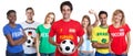Spanish soccer fan with ball and cheering group of other fans Royalty Free Stock Photo