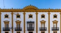 Spanish style architecture building in white and yellow in downtown Zafra