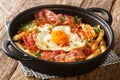 Spanish style fried egg with French fries and jamon close-up in a plate. horizontal Royalty Free Stock Photo