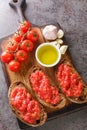 Spanish style toast with tomato Pan con tomate closeup on the wooden board. Vertical top view Royalty Free Stock Photo