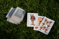 Spanish-suited cards on grass background. Pile of Spanish deck cards