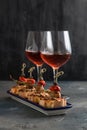 Spanish tapa pinxtos with tuna, peper, onion and oregano. Wine on background Royalty Free Stock Photo