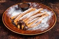 Spanish tapas churros with sugar and chocolate sauce. Dark background. Top view Royalty Free Stock Photo