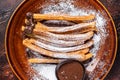 Spanish tapas churros with sugar and chocolate sauce. Dark background. Top view Royalty Free Stock Photo