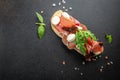 Spanish Tapas with cured Slices of jamon iberico ham with basil on a dark background. banner, menu, recipe place for text, top Royalty Free Stock Photo
