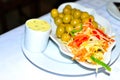 spanish tapas dish cabbage, carrots and pepper salad,olives and garlic and parsley butter.