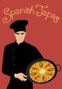 Spanish Tapas. Handsome Spanish chef wearing a kitchen hat holding a pan with typical Spanish Paella