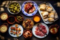 Spanish tapas on a wooden table. Top view with copy space