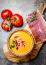 Spanish tomato soup Salmorejo served in olive wooden bowl with ham jamon serrano on stone background. Top view Royalty Free Stock Photo