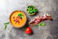 Spanish tomato soup Salmorejo served in olive wooden bowl with ham jamon serrano on stone background. Top view Royalty Free Stock Photo