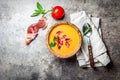 Spanish tomato soup Salmorejo served in olive wooden bowl with ham jamon serrano on stone background. Top view, copy Royalty Free Stock Photo
