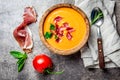 Spanish tomato soup Salmorejo served in olive wooden bowl with ham jamon serrano on stone background. Top view Royalty Free Stock Photo