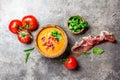 Spanish tomato soup Salmorejo served in olive wooden bowl with ham jamon serrano on stone background. Top view Royalty Free Stock Photo