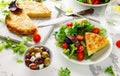 Spanish tortilla, omelette with potato, onion, vegetables, tomatoes, olives and herbs in a white plate. breakfast Royalty Free Stock Photo