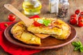 Spanish tortilla, traditional dish with eggs and fried potatoes on a clay plate on a wooden background. Potato recipes Royalty Free Stock Photo