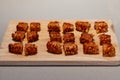 Spanish traditional chopped fried bacon strips Torreznos on a woode