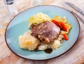 Spanish traditional dish - pork cheeks with cabbage