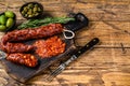 Spanish traditional tapas Sliced chorizo salami, chorizo sausage. wooden background. Top view. Copy space Royalty Free Stock Photo