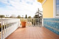 spanish villa terrace with iron railing and tiles