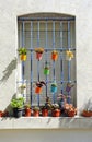 Spanish window adorned with colored pots in house of Southern Spain