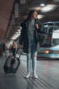 Spanish woman in black coat at a bus station Royalty Free Stock Photo