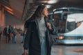 Spanish woman in black coat at a bus station Royalty Free Stock Photo