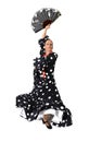 Spanish woman dancing Sevillanas wearing fan and typical folk black with white dots dress