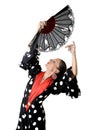 Spanish woman dancing Sevillanas wearing fan and typical folk black with white dots dress