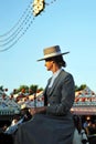 Spanish woman riding at horse in the Seville Fair, feast in Spain Royalty Free Stock Photo