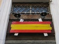 Spanish wooden flag before a window