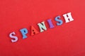 SPANISH word on red background composed from colorful abc alphabet block wooden letters, copy space for ad text. Learning english