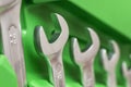 Spanner kit of shiny metal spanners in green box. Wrenchs. Working wrench. Set of metal wrenches. Repair tools