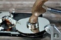 Spanner wrench and steel hammer with HDD platters, hard disk drive disassembled damaged components, computer maintenance, recovery Royalty Free Stock Photo