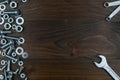 Spanners, bolts and nuts on dark wooden surface