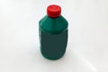 Spare part for car stop system brake fluid one liter bottle in green color with red cap on a white isolated background. Royalty Free Stock Photo