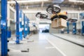 Spare part delivery drone at garage storage in leading automotive car service center for delivering mechanical shipping component