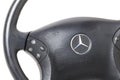 Spare part and interior element from a Mercedes-Benz car driver steering wheel on a white isolated background. Auto service