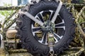 The spare wheel of the buggy racing car is black in color with a beautiful disc pattern.