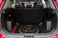 Spare wheel in the trunk of a modern car. Royalty Free Stock Photo