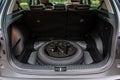 Spare wheel in the trunk of a modern car. Royalty Free Stock Photo