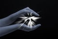 Spark of hope in a woman hand on dark background. The light of faith. Protection light Royalty Free Stock Photo