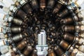 Spark plug on a background of used spark plugs arranged in a circle Royalty Free Stock Photo