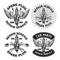 Spark plug with wings, car repair service set of four vector emblems, logos, badges, labels, stickers in monochrome Royalty Free Stock Photo