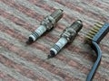 Spark plugs automobile and brush lie on the table Royalty Free Stock Photo