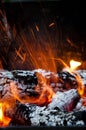 Sparking balefire with flames light. Wood campfire. fireplace. bonfire closeup. fire and firewood turned into coal ash. burning Royalty Free Stock Photo